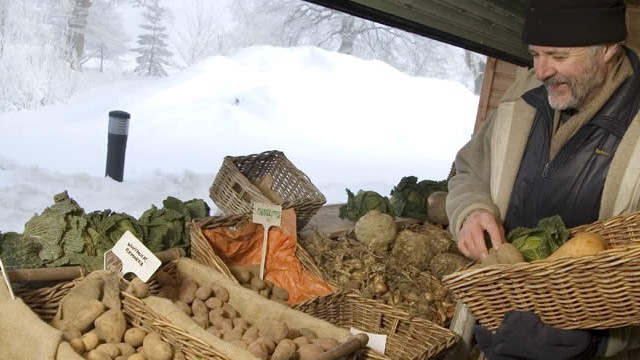 Vegetables being displayed in front of a snow covered farmyard